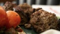 Typical Lebanese dish based on pieces of meat is roasted minced meat with a side of cooked tomatoes