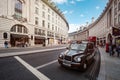 Typical London taxi and double decker bus at Regent Street Royalty Free Stock Photo