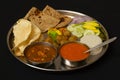 Typical Maharashtrain lunch dish with Chapati, mango juice or aamras,rice, onion and vegetable.