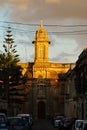 Typical maltese church in sunset hidden between small historical streets