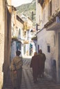 Typical man in morocco in a typical street going up stairs