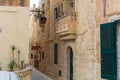 Narrow medieval yellow limestone street of Mdina