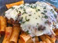 Chicken parmesan, over ziti noodles, topped with mozzarella cheese, parsley