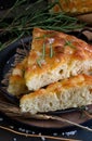 Mediterranean focaccia with olive oil and rosemary on a dark background Royalty Free Stock Photo