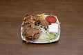 Typical mixed plate of Pakistani restaurants in Europe with lamb and chicken kebab meat, falafel medallion, black olives with Royalty Free Stock Photo