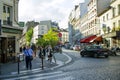 Typical Montmartre streets of old town. Bacchus repair, lepic optic, tibetan restaurant, except, basil restaurant Royalty Free Stock Photo