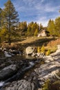 Typical mountain hut on the river in the Alps on the Simplonpass Royalty Free Stock Photo