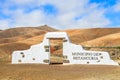 Typical municipality sign white arch gate near Betancuria village with desert mountain landscape in the background, Royalty Free Stock Photo