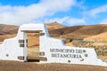 Typical municipality sign white arch gate near Betancuria village with desert mountain landscape in the background, Royalty Free Stock Photo