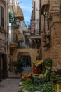typical narrow alley in the old historic center of Bari Vecchio with a vegetable and fruit stall on the corner