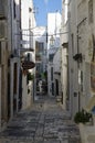 Typical narrow little street with a lots of stairs in Ostuni, La Citta Bianca. Ostuni. Puglia, Italy