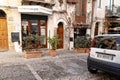 Typical narrow street in Sicilian city of Cefalu with an office of the Noema Viaggi travel agency Royalty Free Stock Photo