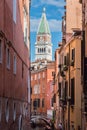 Typical Narrow Street in Venice and St. Marks Bell Tower - Campanile in Background Venice, Italy