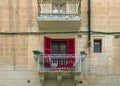 Typical narrow streets with colorful balconies at traditional buildings in Valletta, capital of island of Malta, Europe Royalty Free Stock Photo