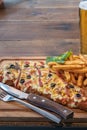 Typical Neapolitan Milanese typical food from Argentina and Uruguay served with French fries and on wooden board Royalty Free Stock Photo