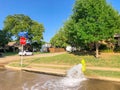 Typical neighborhood area with stop sign near Dallas, Texas, America with open yellow fire hydrant