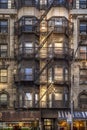Typical New York City building with fire escape ladders Royalty Free Stock Photo