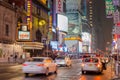 Typical New York Manhattan Avenue Near Times Square. Vehicles Moving on the Road, Broadway Theaters, Billboards, Screens