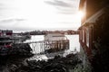 Typical Norwegian fishing village with traditional red rorbu huts, Reine, Lofoten Islands, Norway - fischer mole for boats Royalty Free Stock Photo