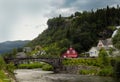 Typical Norwegian house near one of the most popular waterfalls in Norway - Steinsdalsfossen, on the Fosselva river in Royalty Free Stock Photo