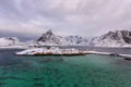 Typical Norwegian landscape. Beautiful view of scenic Lofoten Islands winter scenery with traditional yellow fisherman Rorbuer cab Royalty Free Stock Photo