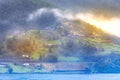 Norwegian old wooden houses and fog in summer, Norway Royalty Free Stock Photo