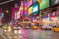 Typical NYC Manhattan Avenue Near Times Square at Night. Vehicles Moving on the Road, Broadway Theaters, Billboards, LED Screens