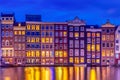 Typical old dutch houses over canal with reflections at twilight in Amsterdam, North Hilland, Netherlands. Amsterdam postcard Royalty Free Stock Photo