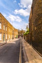 Typical old English buildings, low brick buildings across a narrow street, interesting old London architecture. Royalty Free Stock Photo