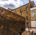 Typical old English buildings, low brick buildings across a narrow street, interesting old London architecture. Royalty Free Stock Photo