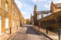 Typical old English buildings, low brick buildings across a narrow street, interesting old London architecture. Royalty Free Stock Photo