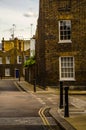 Typical old English buildings, low brick buildings across a narrow street, interesting old London architecture Royalty Free Stock Photo