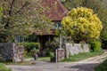 A typical old English cottage on a country lane Royalty Free Stock Photo