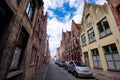 Typical old narrow paved street with traditional brick houses in Bruges. Royalty Free Stock Photo