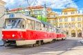 Typical old retro vintage tram on tracks near tram stop in the streets of Prague city near Sternberg palace Royalty Free Stock Photo