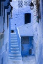 Old narrow blue painted street in the medina of Chefchaouen, Morocco Royalty Free Stock Photo