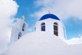 Typical orthodox church with blue dome and golden cross in Santorini Royalty Free Stock Photo