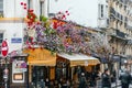 Typical Parisian cafe decorated with flowers in Paris, France