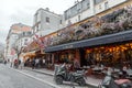 Typical Parisian cafe decorated with flowers in Paris, France