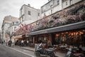 Typical Parisian cafe decorated with flowers in Paris, France