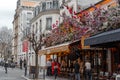 Typical Parisian cafe decorated with flowers in Paris, France