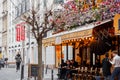 Typical Parisian cafe decorated with flowers in Paris, France