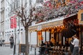 Typical Parisian cafe decorated with flowers in Paris, France