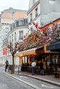 Typical Parisian cafe decorated with flowers in Paris, France