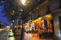 Typical Parisian cafe Le Parvis at rainy night located next famous Notre Dame cathedral in Paris, France. Royalty Free Stock Photo