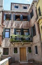 Typical patio with in the city of Venice, beautiful flowers balcony with a windows in the house Royalty Free Stock Photo