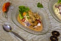 Typical Peruvian ceviche with sea bass and seafood, rocoto tiger milk, sweet potato and corn puree served in a glass dish