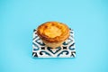 typical portugese egg tart pastel de nata on blue background