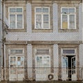 Typical Portuguese Architecture: Tile Azulejos Facade with Antique Windows And Balcony - Portugal Royalty Free Stock Photo