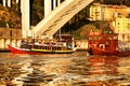 Typical portuguese boats called Rabelos crossing the Douro River Royalty Free Stock Photo